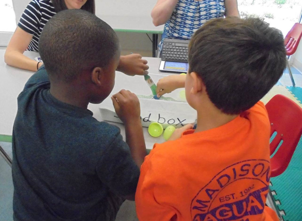 Interns work with kids in clinic